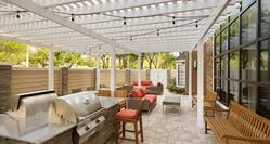 Outdoor covered patio with grills and comfortable seating