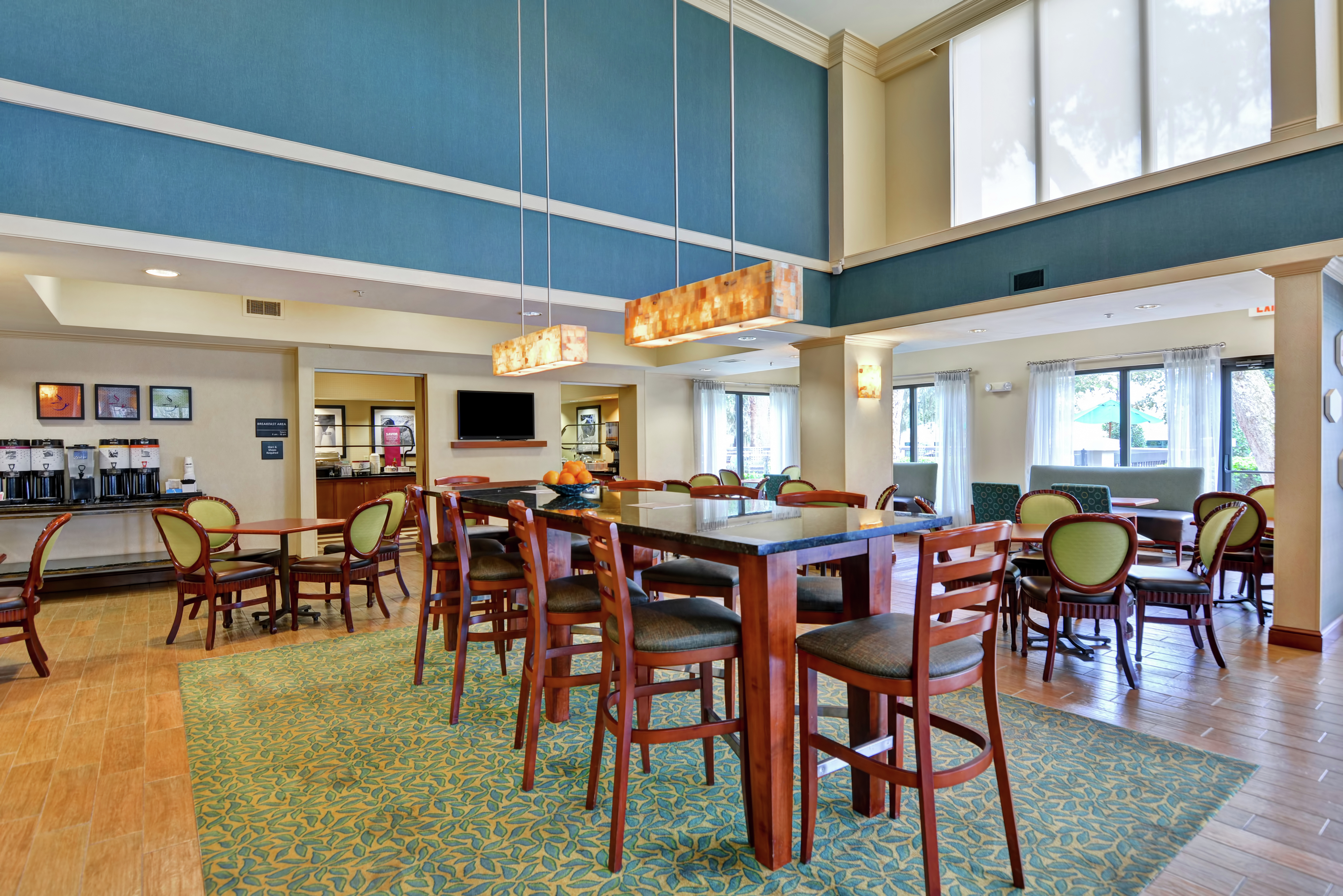Lobby dining area with large table and TV
