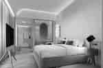 Suite bedroom with one king bed, a TV on a tripod crafted stand, along with a sitting area.
