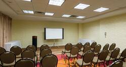  Meeting Room Arranged Theater Style With Rows of Chairs Facing Projector Screen