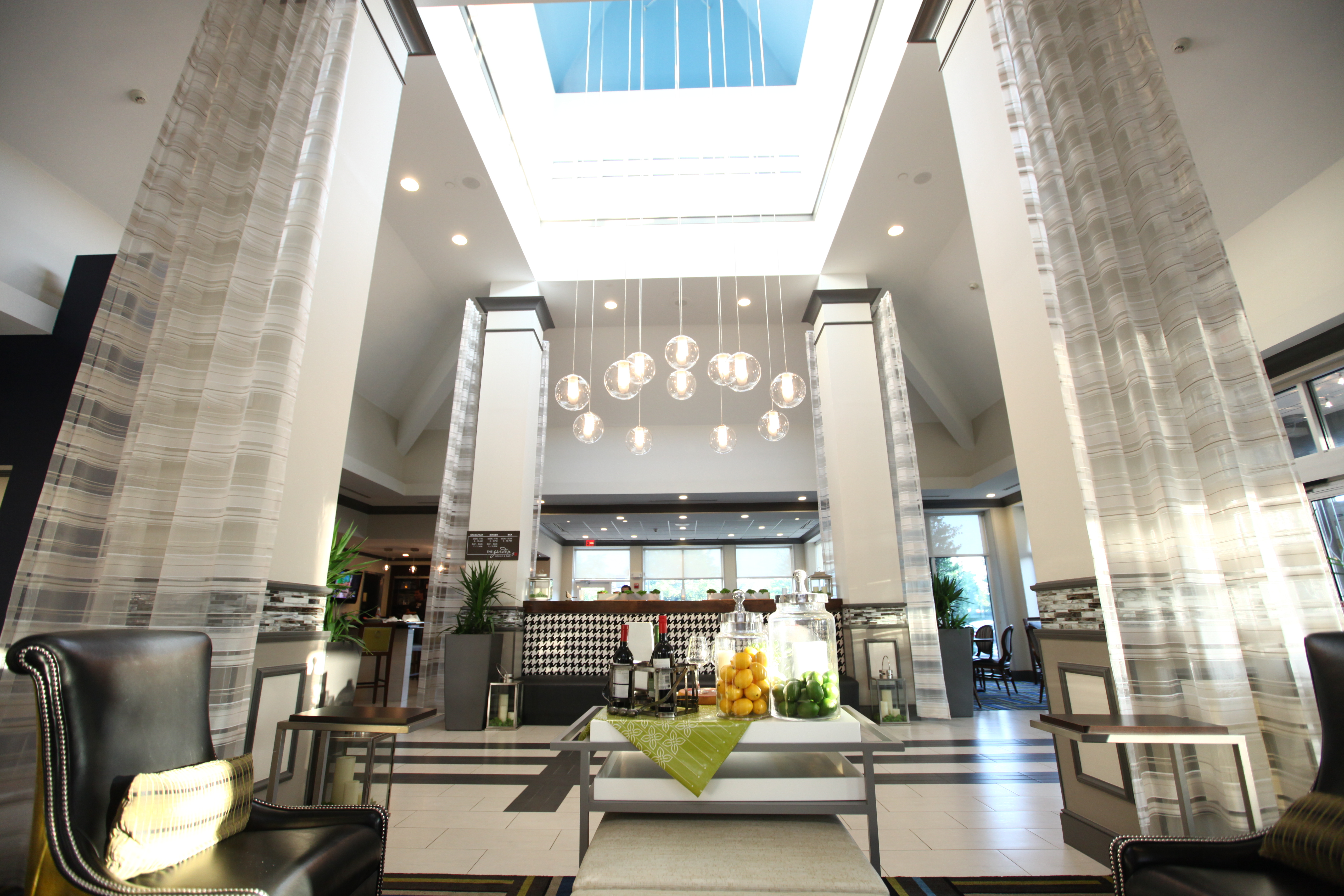 Lobby With Long Drapes, Soft Seating, and Beverage Station