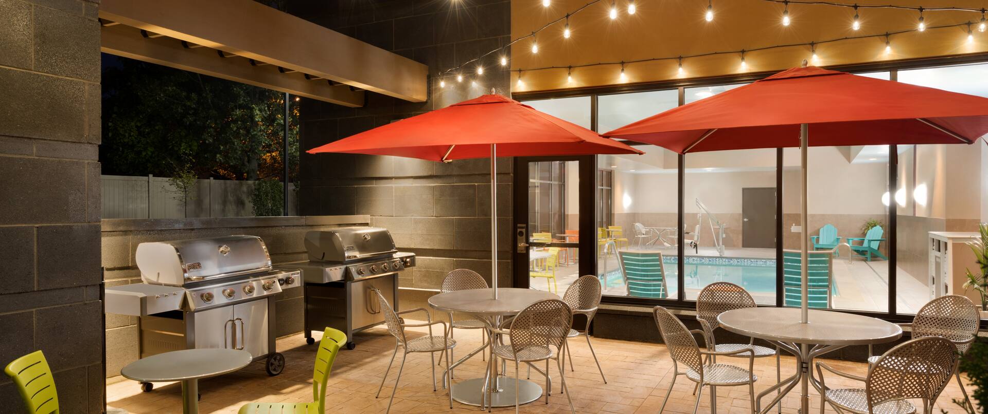 Outdoor Patio with Chairs, Tables, Umbrellas and Grills