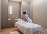 Spa Treatment Room With Member Of Staff