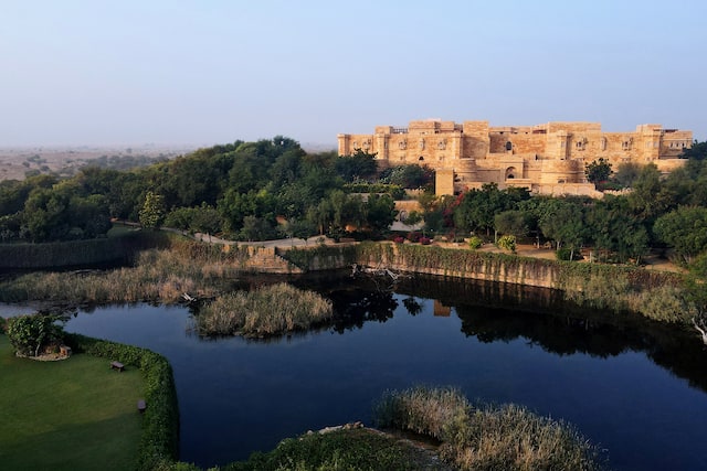 Suryagarh Jaisalmer Hotel Exterior with Trees and a Pond