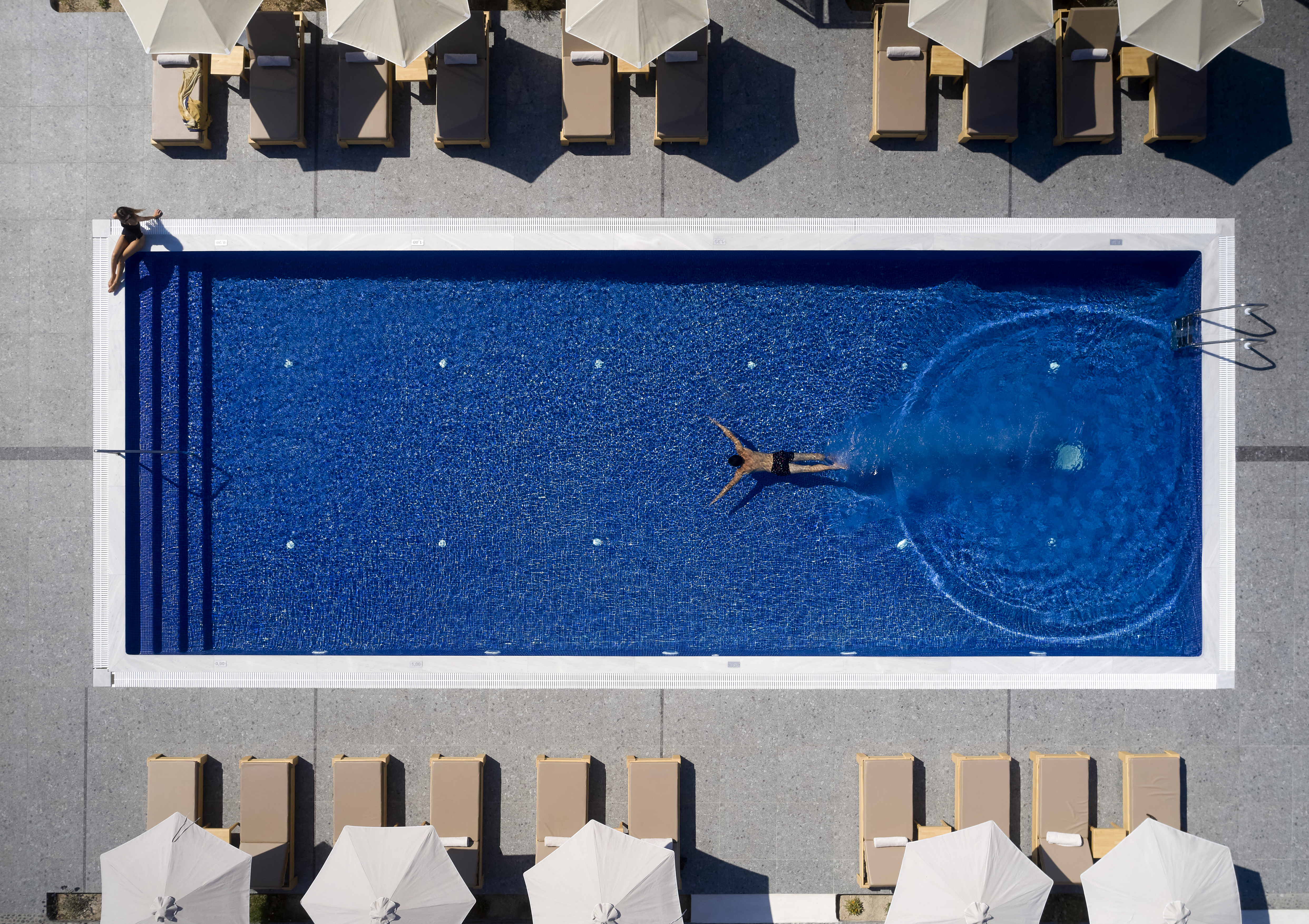 man swimming in outdoor pool