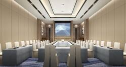Meeting Room arranged with long tables and chairs with projector screen