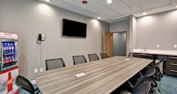 Meeting Room with Table, Office Chairs, Coca-Cola Mini Fridge and Wall Mounted HDTV