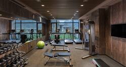 Fitness center cardio and weight machines and free weights bench