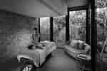Spa single treatment room with staff member massaging guest
