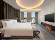 King presidential suite bedroom with wall mounted TV