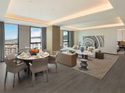 King premier suite lounge area with sofa and dining table