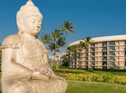Buddha Statue with Hotel Exterior in Background