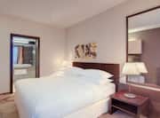 Large Bed Mirror and Nightstand in Hotel Suite