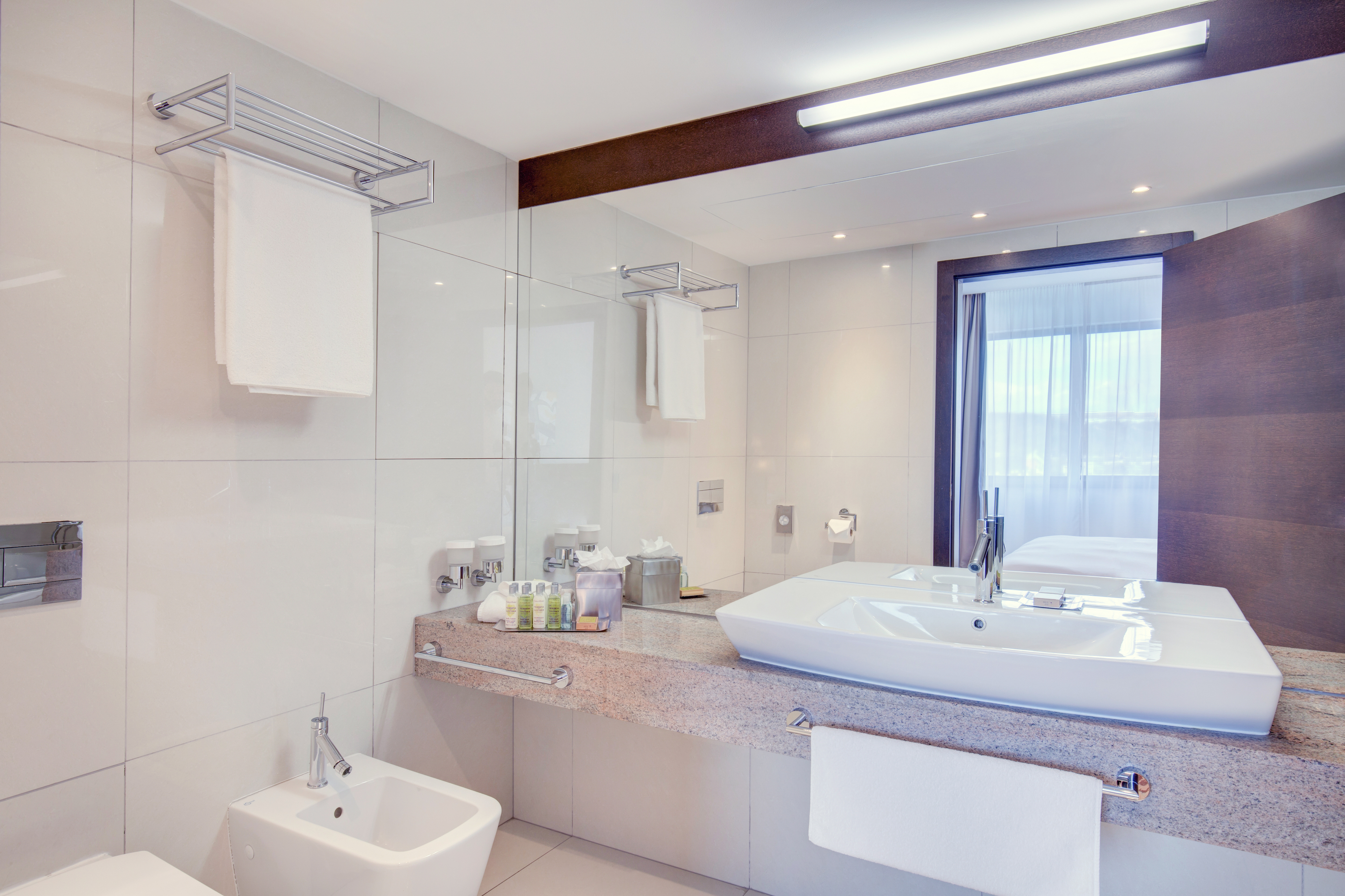 Bathroom Vanity Area with larg Mirror in Suite