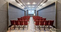 Perdana meeting room with seating and projector screen