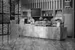 The Koffee service area with a variety of desserts and snacks, and a team member preparing a plate.