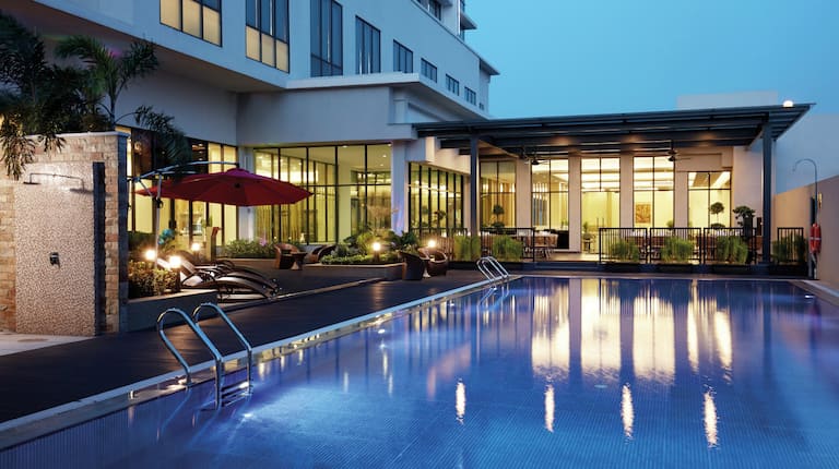 Relax and feel the breeze under the night sky by the pool.