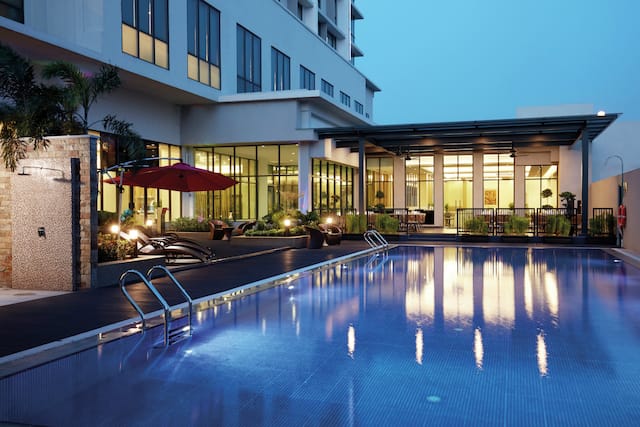 Relax and feel the breeze under the night sky by the pool.