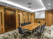 Boardroom with Conference Table and Projector Screen