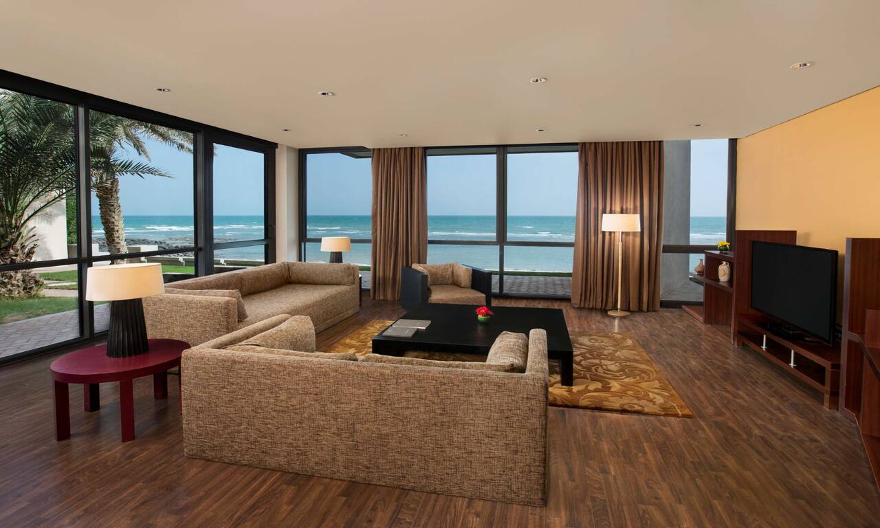 suite living area with large windows