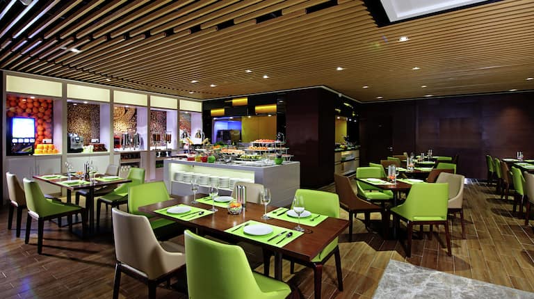 Dining Tables, Chairs, and Food Bar in Restaurant