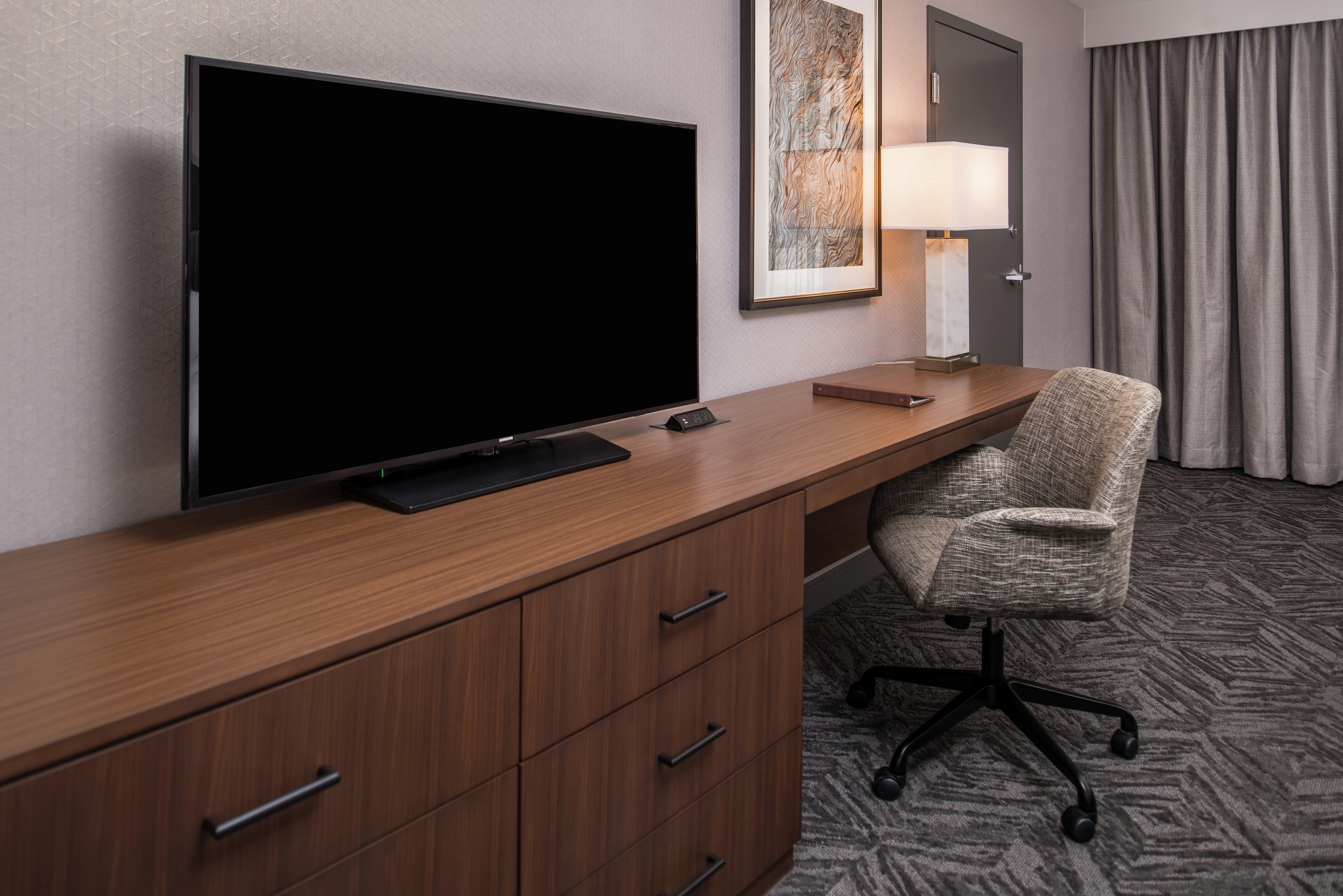 Guest Room With Flat Screen Television, Work Desk, and Chair