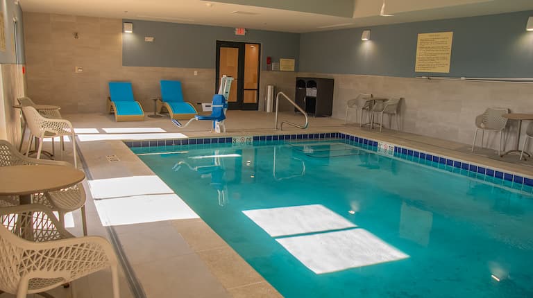 Indoor pool with handrail and seating