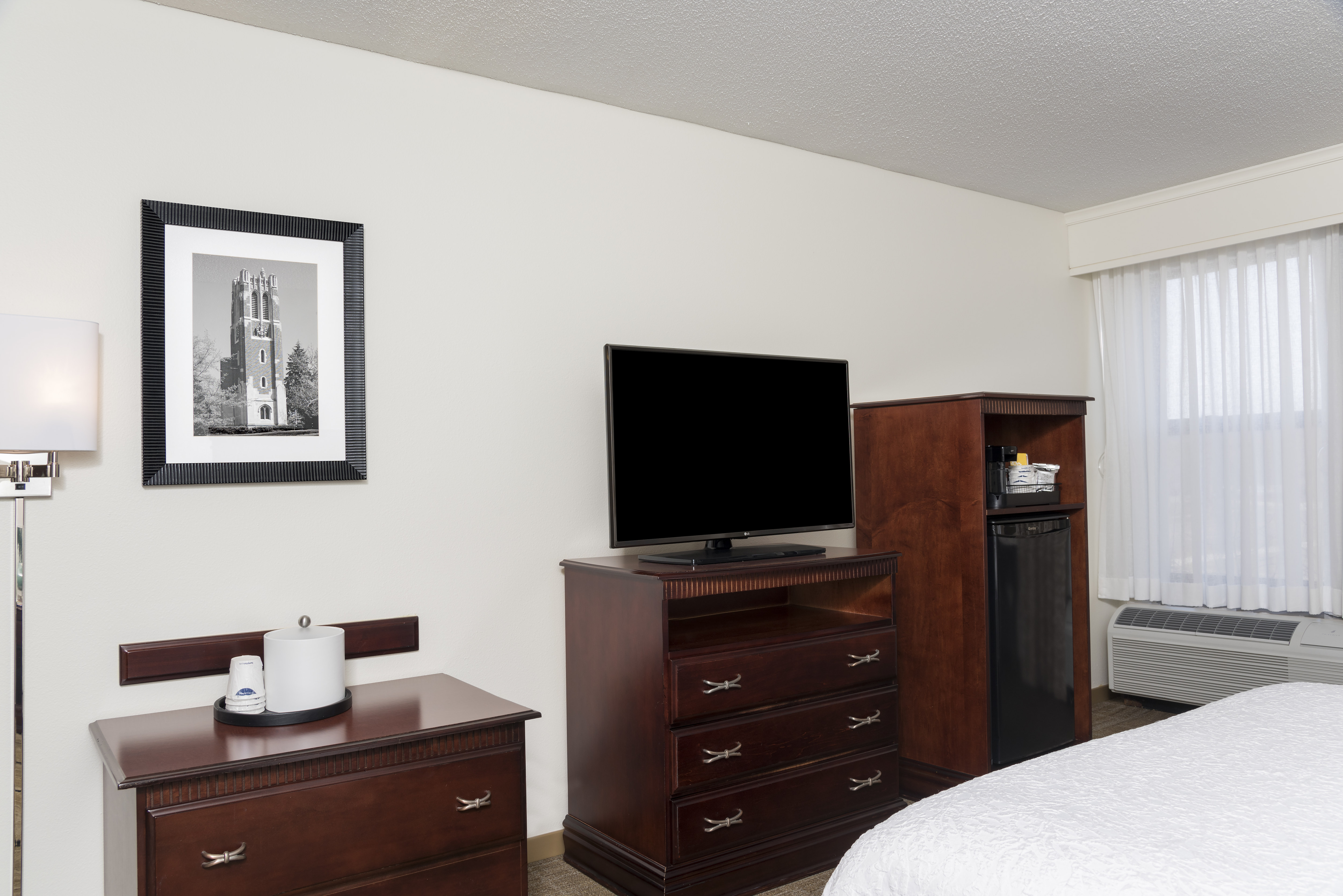 Guestroom with King Bed, Television and Fridge