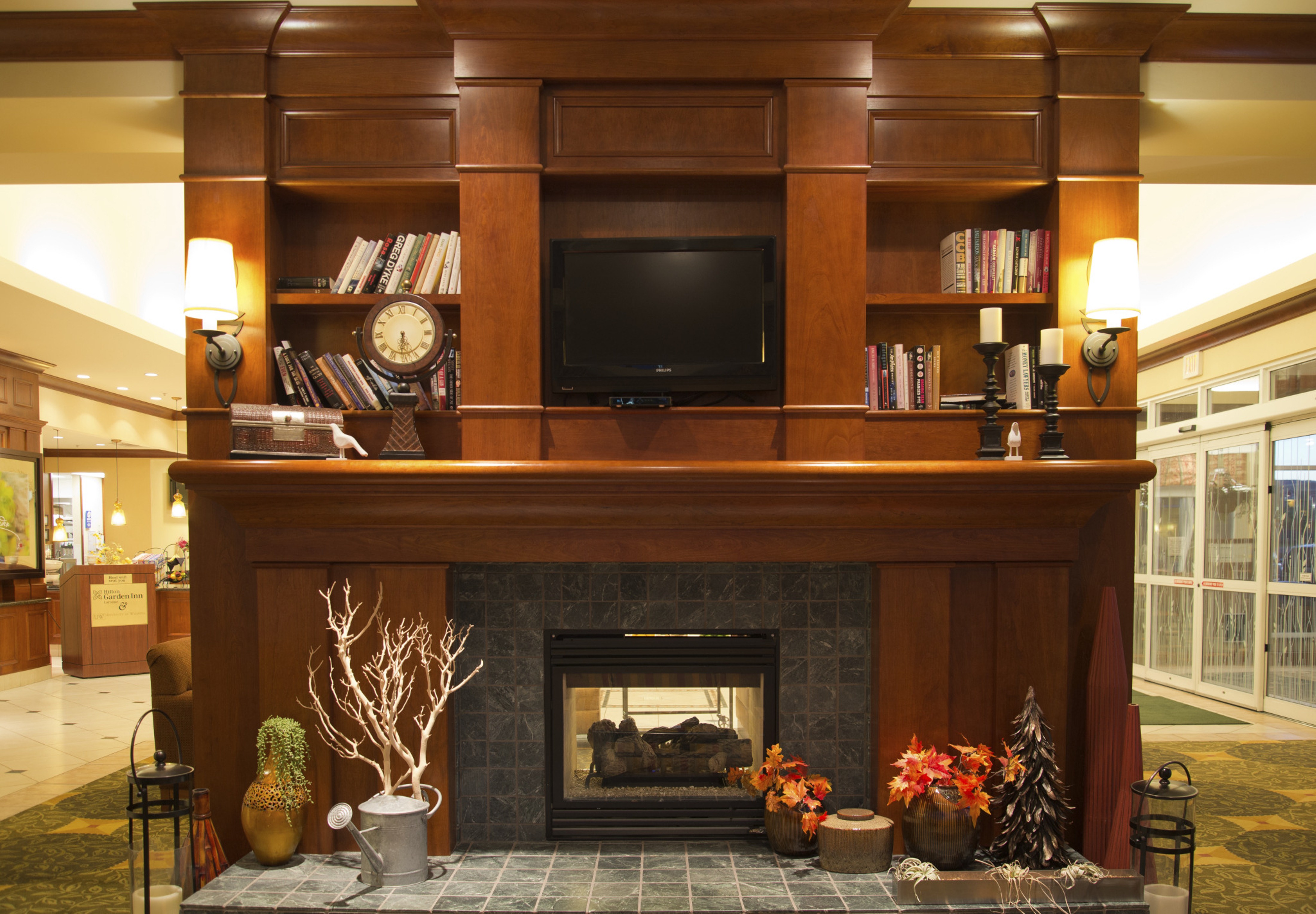 Wood Cabinetry with TV, Lights, Decor and Fireplace in Lobby