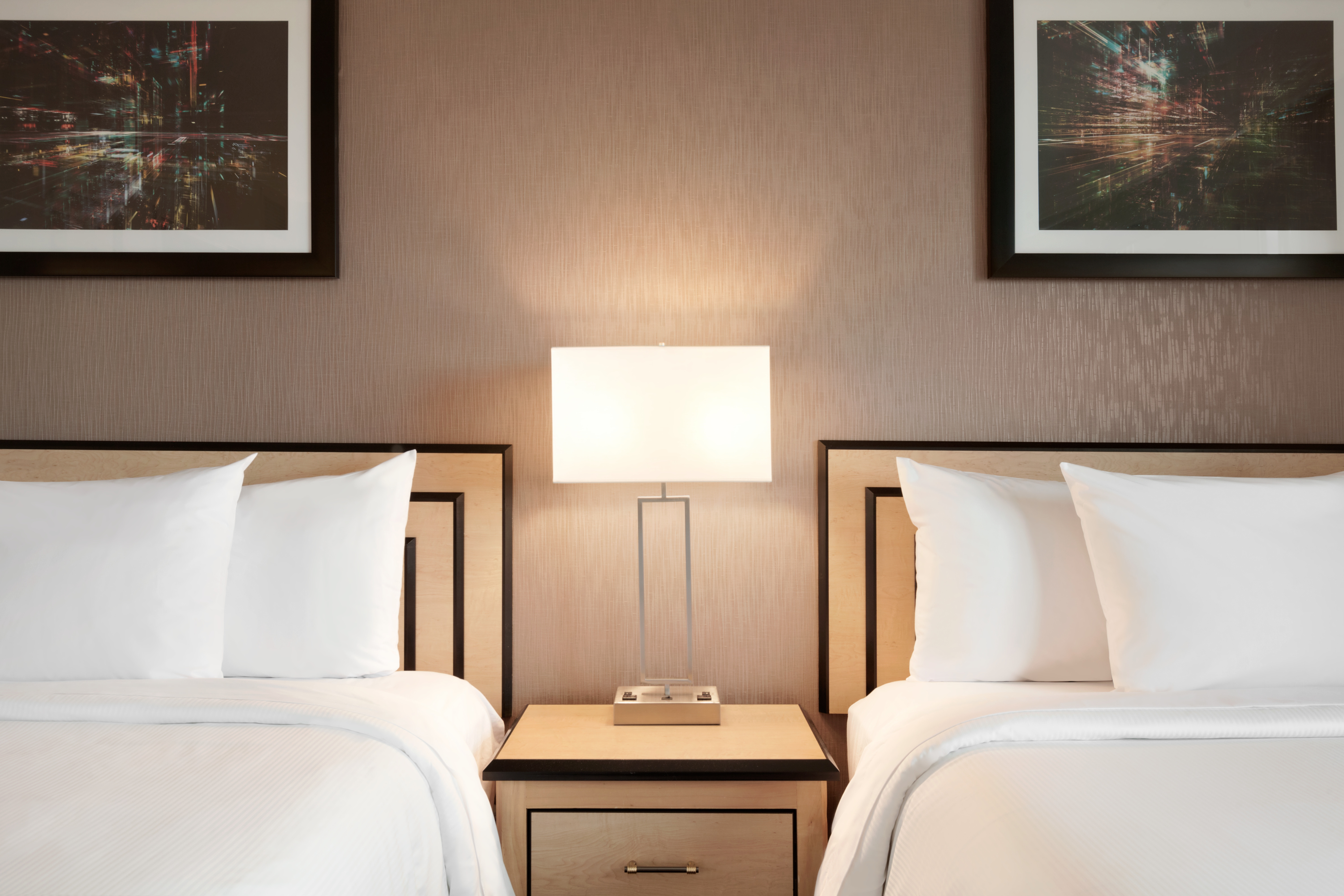 Double Queen Beds Guestroom with Bedside Table and Lamp