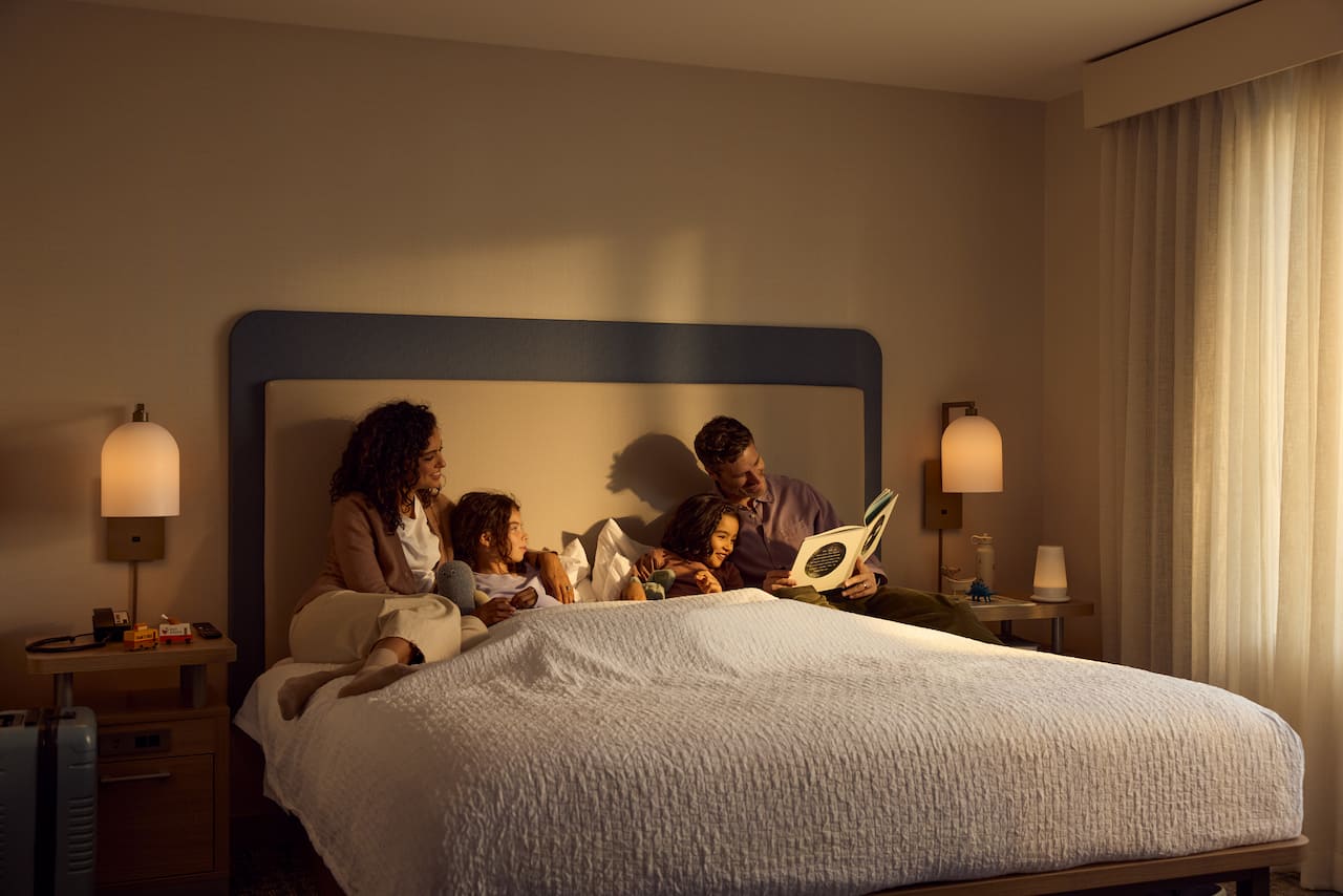 Man and woman reading children a bedtime story in bed