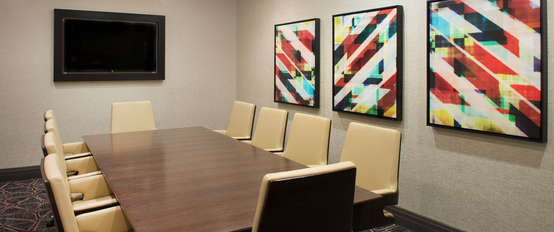 Meeting Room with Tables, Office Chairs and Wall Mounted HDTV