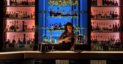 Waldorf Skybar with Bartender Serving Drinks