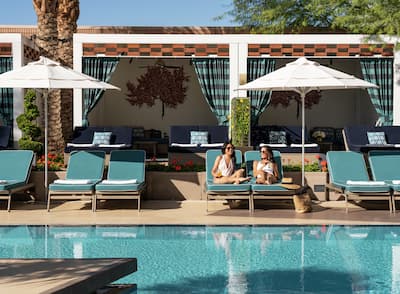 Exterior Pool with Two Women in Lounge Chairs