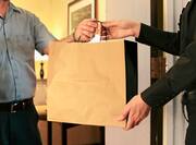 guest services handing a guest a bag