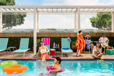 family and couple having fun at outdoor pool