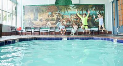 Family Relaxing and Playing in Indoor Pool Area