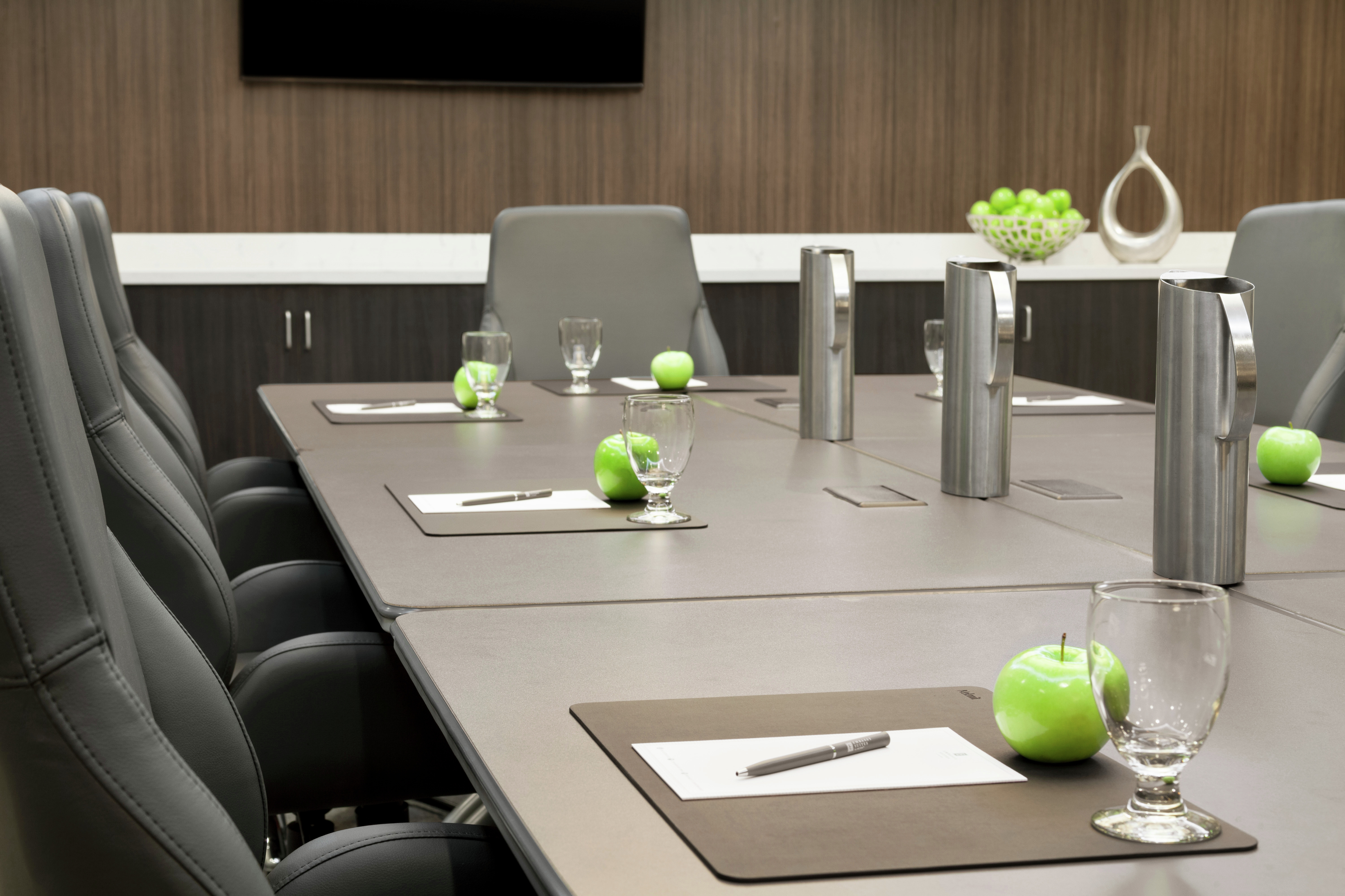 Boardroom with Tables, Chairs, Apples, and Glasses