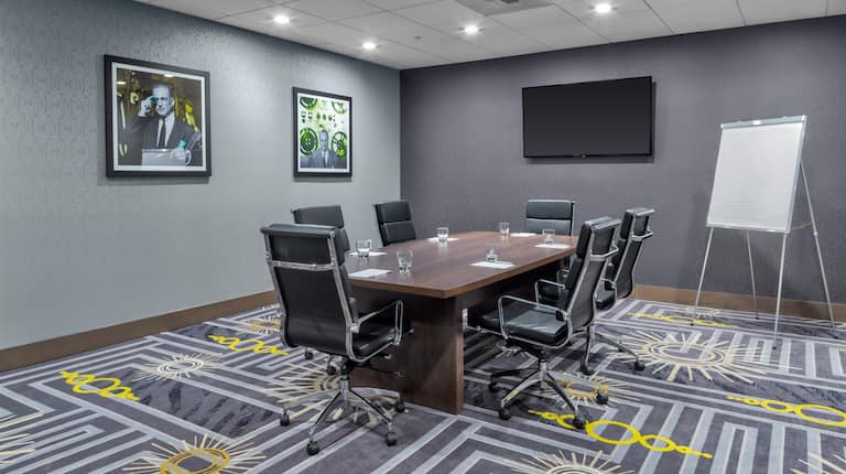 Meeting Room with Table, Office Chairs, Whiteboard and Wall Mounted HDTV