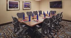 Riviera Boardroom With Wall Art, TV, and Ergonomic Seating for 10 Around Long Table