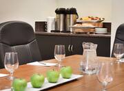 Close Up of Water and Apples on Boardroom Table