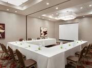 Meeting Room with U-Shaped Conference Table and Projector Screen