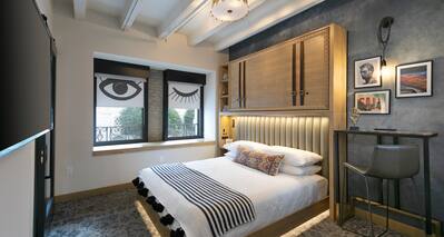 Urban king bedroom with wall mounted TV