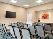 Convenient on-site meeting room fully set in theater style seating, TV for presentations, and refreshment area.