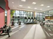 Convenient on-site fitness center fully equipped with TV, cardio equipment, and free weights.