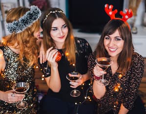 Women enjoying festive celebration with cocktails.