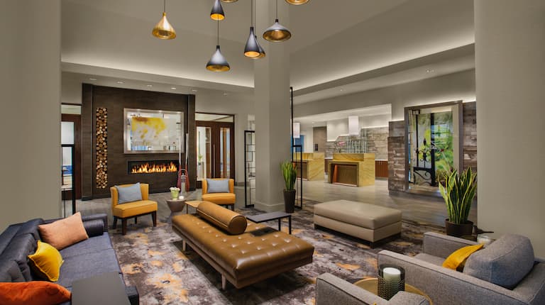 Lobby Lounge Area With Soft Seating, Fireplace, and  View of Front Desk