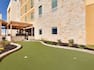  On-Site Putting Green With Two Holes and Landscaping by Building Exterior