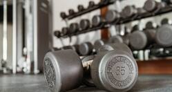 A set of 35lb dumbbells on the floor of a Hampton by Hilton fitness center. 