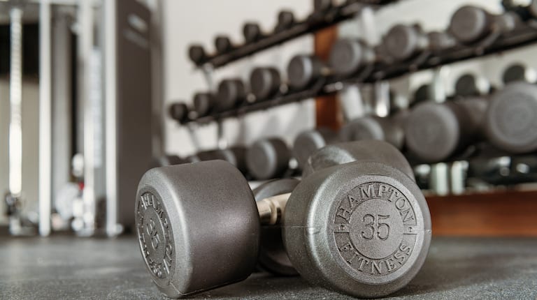 A set of 35lb dumbbells on the floor of a Hampton by Hilton fitness center. 